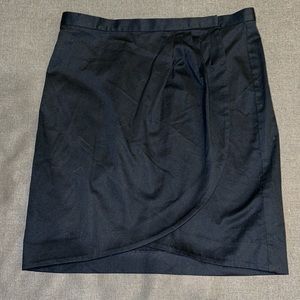 Michael Kors ladies black wrap skirt. Size 8. Curved edging in front.